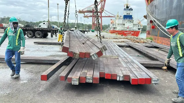 Crew landing a set of steel billets on the dock