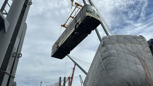 Ship's crane lifting a large cargo unit