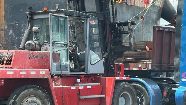 Heavy forklift handling cargo on the dock