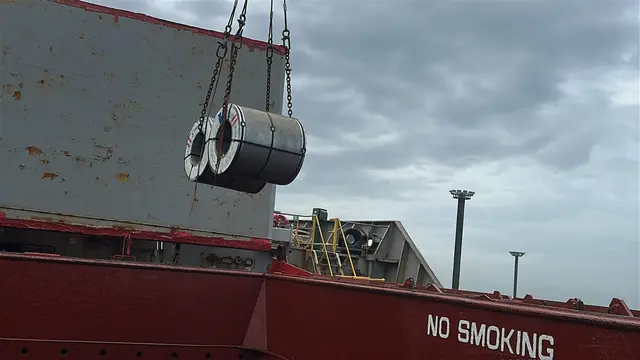 Steel coil lifted over the deck