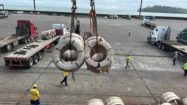 Steel coils lifted over the yard, sea and island on the horizon